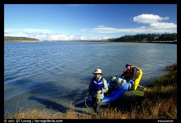 Canoeist with inflatable canoe on the shores of Kobuk River. Kobuk Valley National Park, Alaska (color)