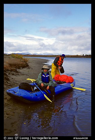 Canoeists finish  loading  with the boat prior to launching. Kobuk Valley National Park, Alaska (color)