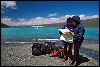 Backpackers orient themselves on the map while the plane is taking off. Lake Clark National Park, Alaska ( color)