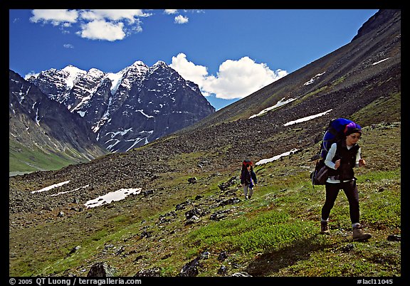 Backpackers walking on a slope. Lake Clark National Park, Alaska (color)