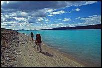 Backpackers walking on the shore of Turquoise Lake. Lake Clark National Park, Alaska ( color)