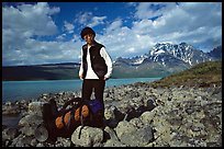 Backpacker pausing on the shore of Turquoise Lake. Lake Clark National Park, Alaska