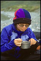 Backpacker eating camp food. Lake Clark National Park, Alaska ( color)