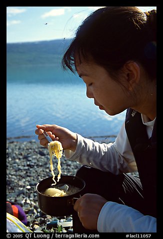 Backpacker eating noodles from a camp pot. Lake Clark National Park, Alaska