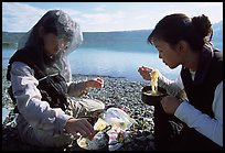 Backpackers eating noodles from a camp pot. Lake Clark National Park, Alaska ( color)