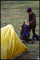 Backpacker unpacking backpack into the tent. Lake Clark National Park, Alaska ( color)