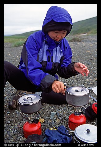 Backpacker cooks meal on gas campstove. Lake Clark National Park, Alaska