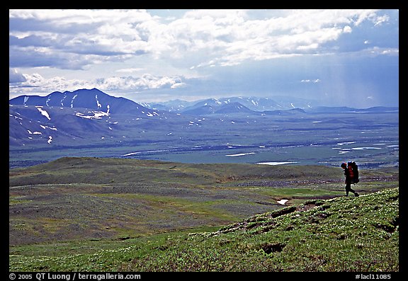 Backpacker on a ridge above vast expenses of tundra. Lake Clark National Park, Alaska