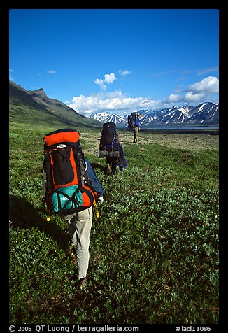 Backpackers with heavy packs. Lake Clark National Park, Alaska