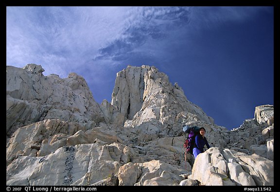 Looking up to woman scrambling on rocks on the East face of Mt Whitney. California (color)