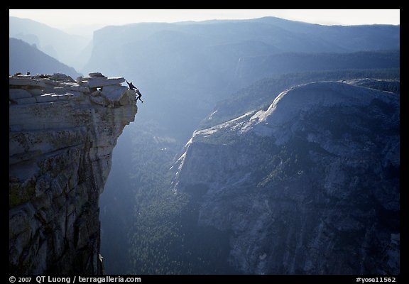 Hanging dramatically from the Jumping Board, Half-Dome. Yosemite National Park, California (color)
