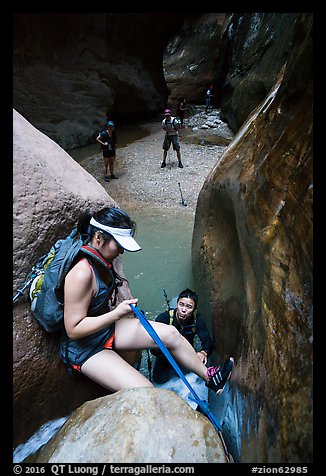 Canyoneer lowers herself using rope, Orderville Canyon. Zion National Park, Utah (color)