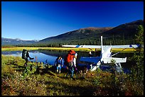 Backpackers beeing picked up by a floatplane at Circle Lake. Gates of the Arctic National Park, Alaska (color)