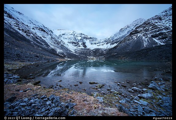 Partly frozen lake and Three River Mountain, dawn. Gates of the Arctic National Park, Alaska, USA.