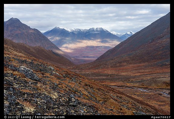 Valley with sunlit slopes in the distance. Gates of the Arctic National Park, Alaska, USA.
