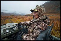Nunamiut subsistence hunter driving all-terrain vehicle. Gates of the Arctic National Park ( color)