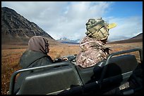 Nunamiut family on all-terrain vehicle from the back. Gates of the Arctic National Park ( color)