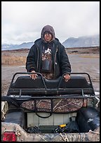 Nuamiunt boy standing on all-terrain vehicle, Anaktuvuk Pass Airport. Gates of the Arctic National Park ( color)
