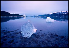 Beached translucent iceberg and Muir inlet at dawn. Glacier Bay National Park, Alaska, USA. (color)