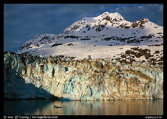 Face of Lamplugh Glacier illuminated by the sun on cloudy day. Glacier Bay National Park (color)
