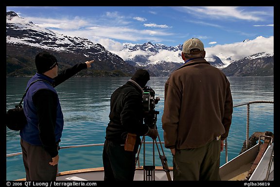 Crew filming from the deck of a boat. Glacier Bay National Park, Alaska, USA.