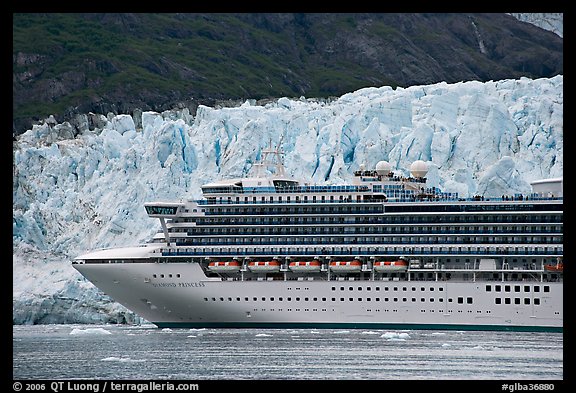 Cruise ship dwarfed by the face of Margerie Glacier. Glacier Bay National Park, Alaska, USA.