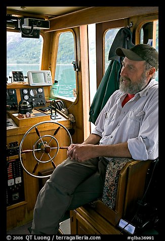 Captain sitting at the wheel. Glacier Bay National Park (color)