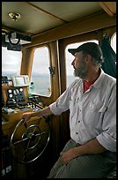 Captain steering boat using navigation instruments. Glacier Bay National Park ( color)