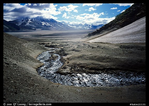 Stream flows from the hills into the floor of the Valley of Ten Thousand smokes. Katmai National Park, Alaska, USA.