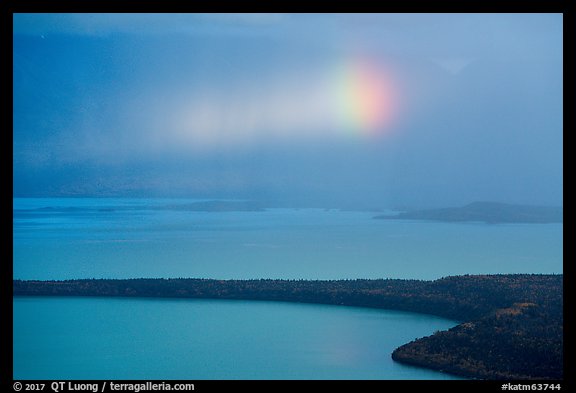 Rainbow in sun shaft piercing clouds. Katmai National Park, Alaska, USA.