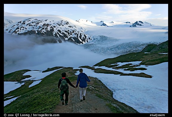 Couple hiking down Harding Icefied trail, late afternoon. Kenai Fjords National Park (color)