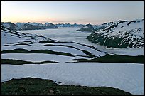 Bands freshly uncovered by snow, and low clouds, sunrise. Kenai Fjords National Park, Alaska, USA. (color)