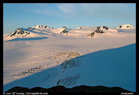 Snow-covered glacier and Harding Ice field peaks, sunrise. Kenai Fjords National Park (color)