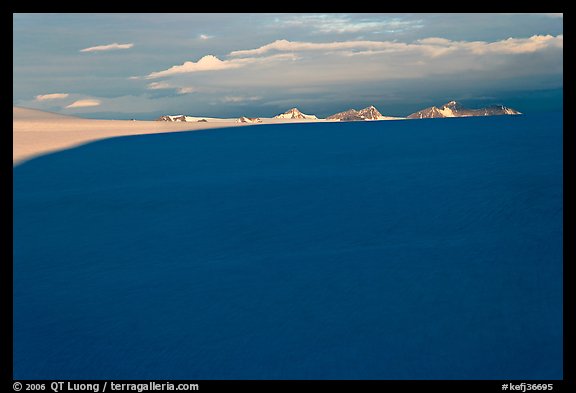 Distant mountains emerging from shadows over the Harding field. Kenai Fjords National Park, Alaska, USA.