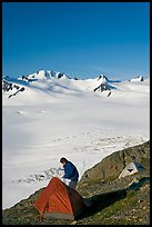 Camper exiting tent above the Harding ice field. Kenai Fjords National Park ( color)
