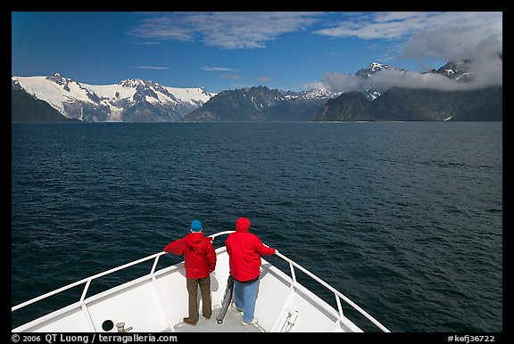Passengers with red jackets on bow of tour boat, Northwestern Fjord. Kenai Fjords National Park, Alaska, USA.