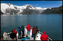 Vistors on bow of tour boat approaching glacier, Northwestern Fjord. Kenai Fjords National Park, Alaska, USA. (color)