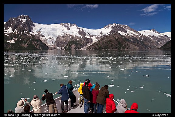 People looking at glaciers as boat crosses ice-chocked waters, Northwestern Fjord. Kenai Fjords National Park, Alaska, USA.