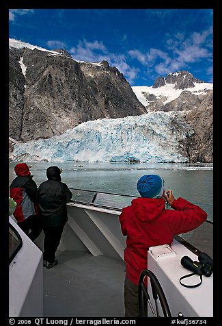 Passengers looking at Northwestern glacier from the deck of tour boat. Kenai Fjords National Park, Alaska, USA.