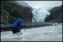Hiker traverses glacial stream, Exit Glacier. Kenai Fjords National Park ( color)