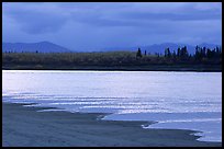 Sand bar shore, bright river and Baird mountains, evening. Kobuk Valley National Park, Alaska, USA. (color)