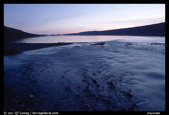 Stream flows into Turquoise Lake, midnight sunset. Lake Clark National Park