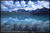 Clouds and Telaquana Mountains above Turquoise Lake, from the middle of the lake. Lake Clark National Park, Alaska, USA.