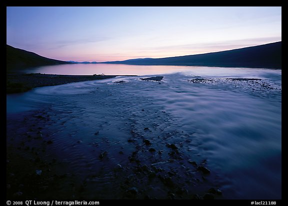 Stream flows into Turquoise Lake, midnight sunset. Lake Clark National Park, Alaska, USA.