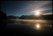 Kontrashibuna Lake and moon at night. Lake Clark National Park, Alaska, USA.