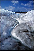 Ice, glacial creek on Root glacier, and mountains. Wrangell-St Elias National Park, Alaska, USA.