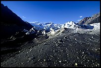Morainic debris on Root glacier with Wrangell mountains in the background, late afternoon. Wrangell-St Elias National Park, Alaska, USA.
