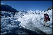 Backpacker with large pack on Root glacier. Wrangell-St Elias National Park ( color)