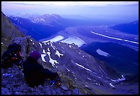 Mountaineer looking down from Mt Donoho. Wrangell-St Elias National Park, Alaska, USA.