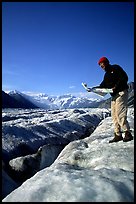 Hiker checks map on Root Glacier. Wrangell-St Elias National Park, Alaska, USA. (color)